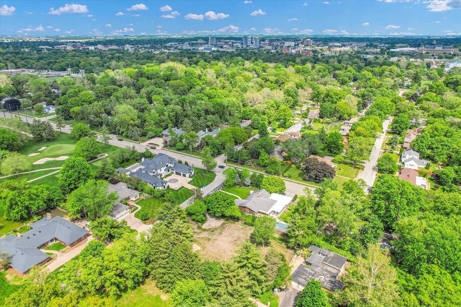 a view of a city with lush green forest