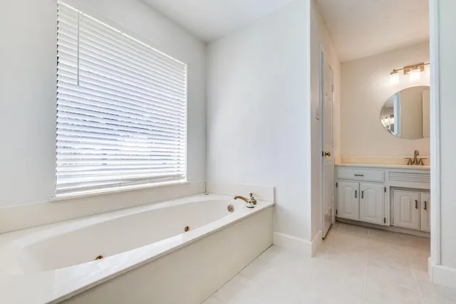 a bathroom with a bathtub and a sink