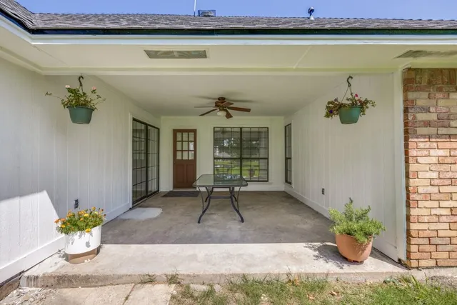 a front view of a house with a potted plant