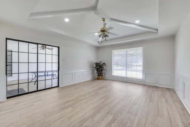 wooden floor in an empty room with a window