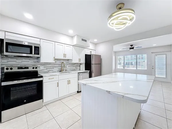 a kitchen with appliances cabinets and a counter top space