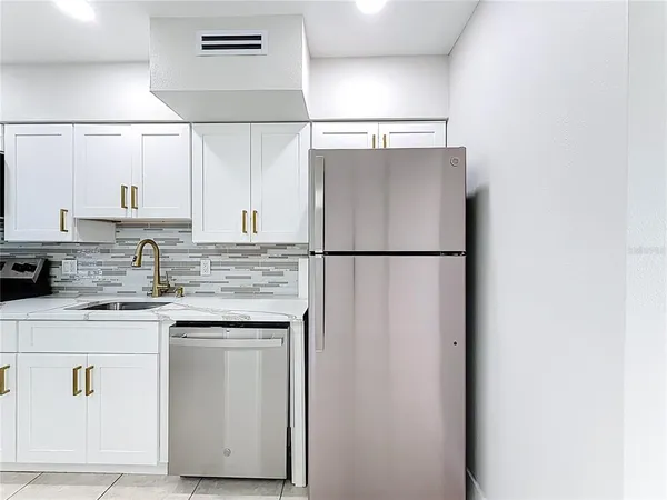 a kitchen with a stove cabinets and microwave