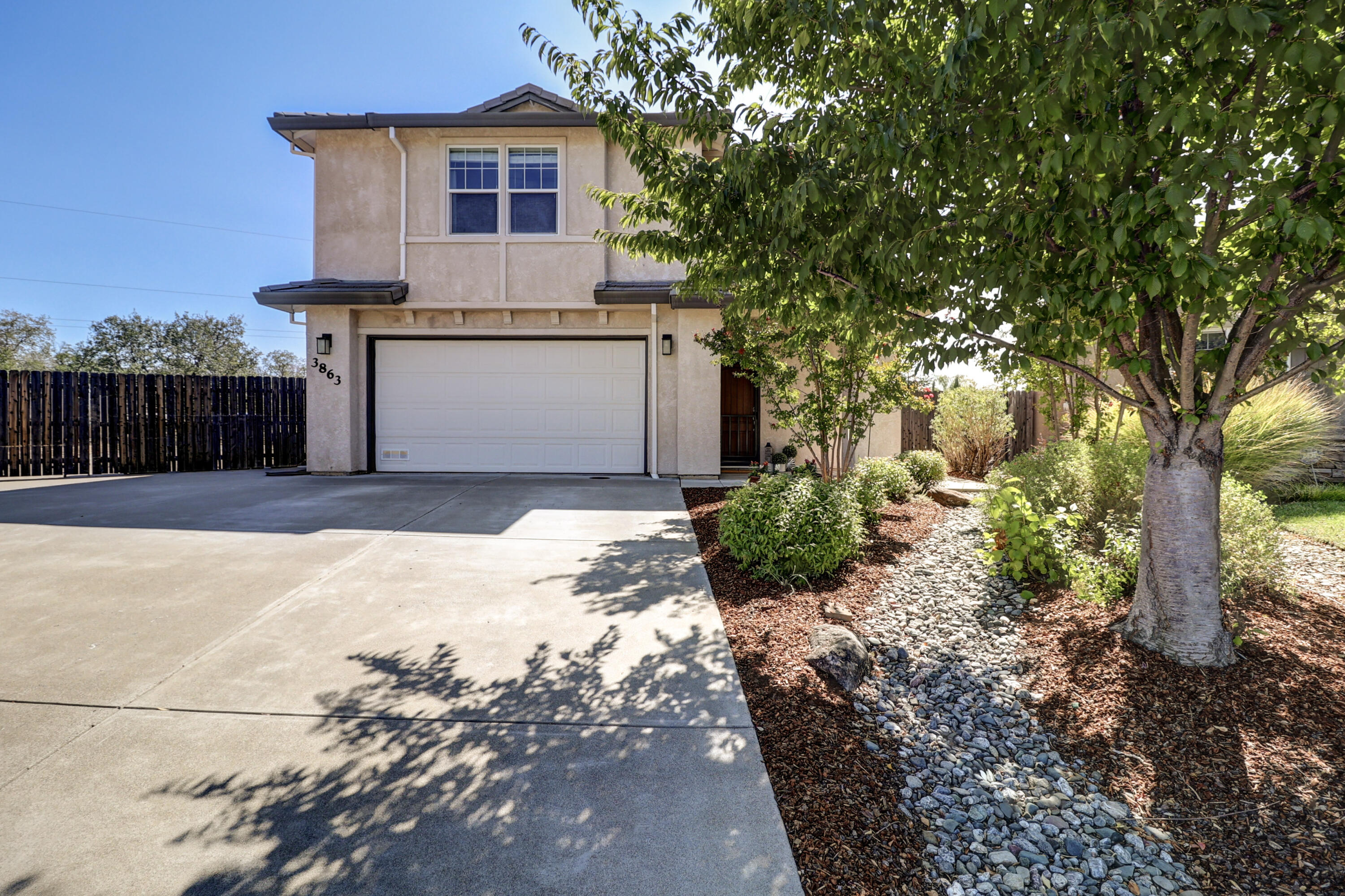 3863 Indian Wells Lane Redding, CA 96002 - Photo 1 of 63 a front view of a house with a yard and garage