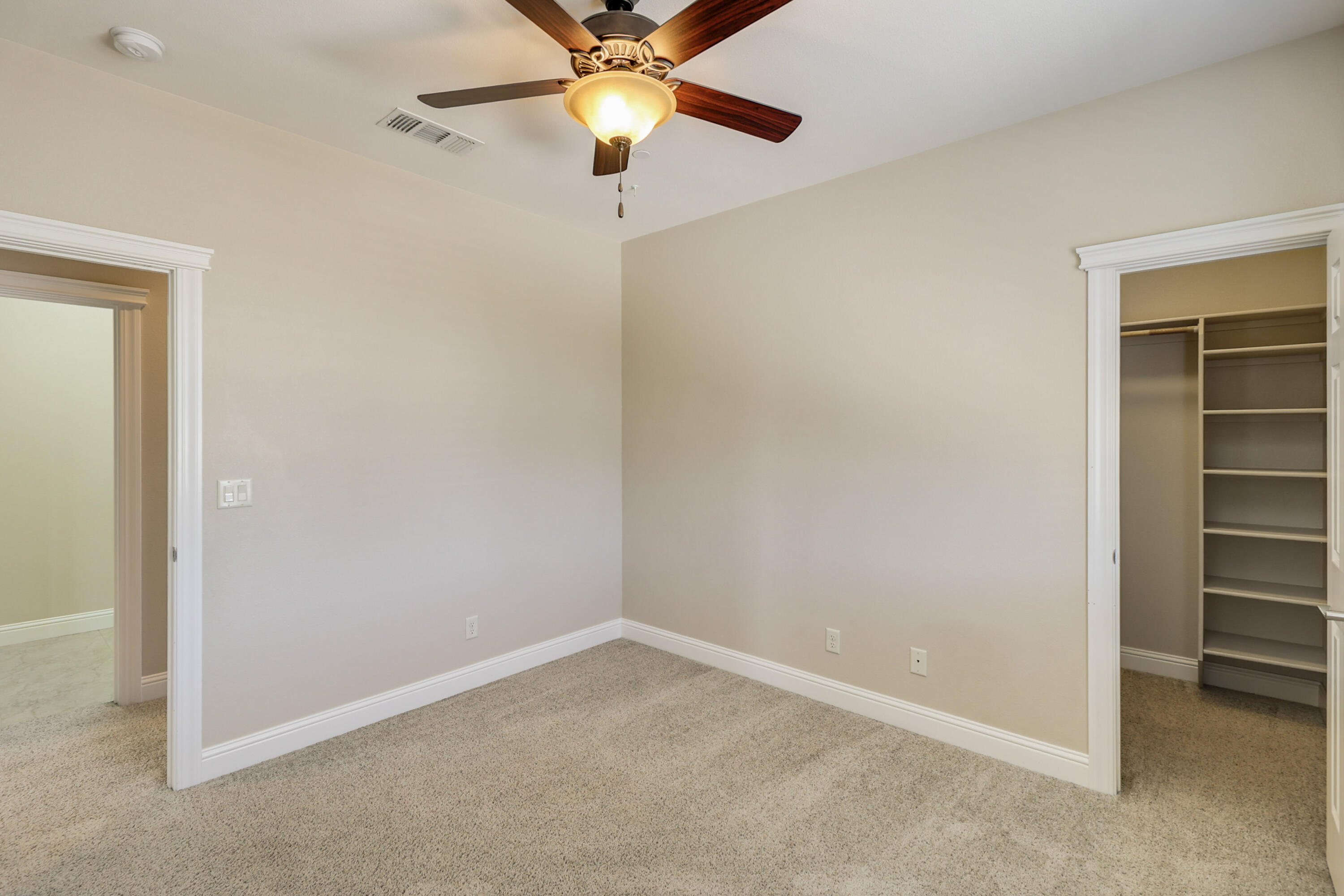 3863 Indian Wells Lane Redding, CA 96002 - Photo 20 of 63 an empty room with closet and a ceiling fan