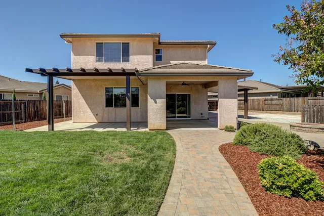 a front view of a house with a garden and plants