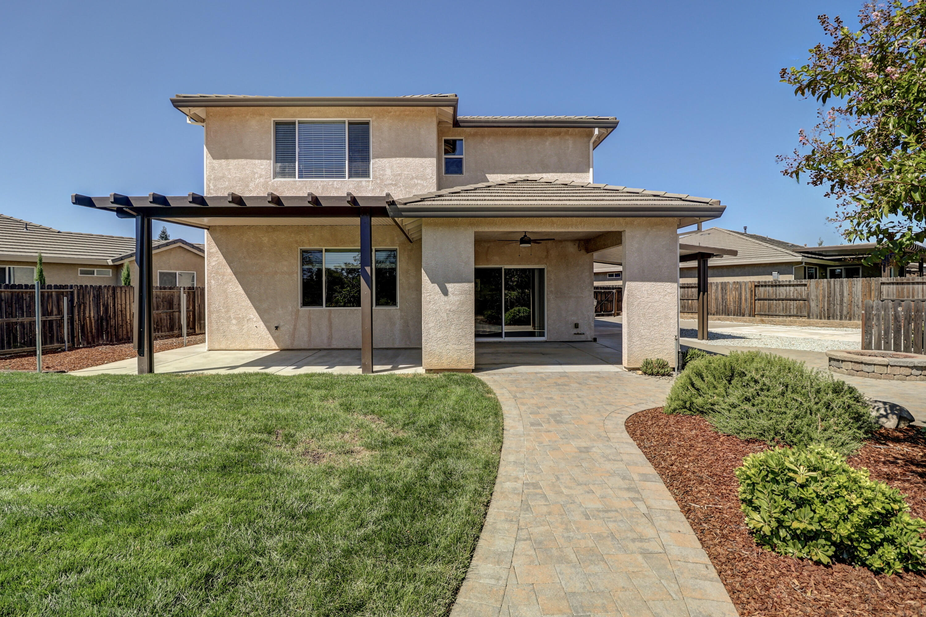 3863 Indian Wells Lane Redding, CA 96002 - Photo 2 of 63 a front view of a house with a garden and plants