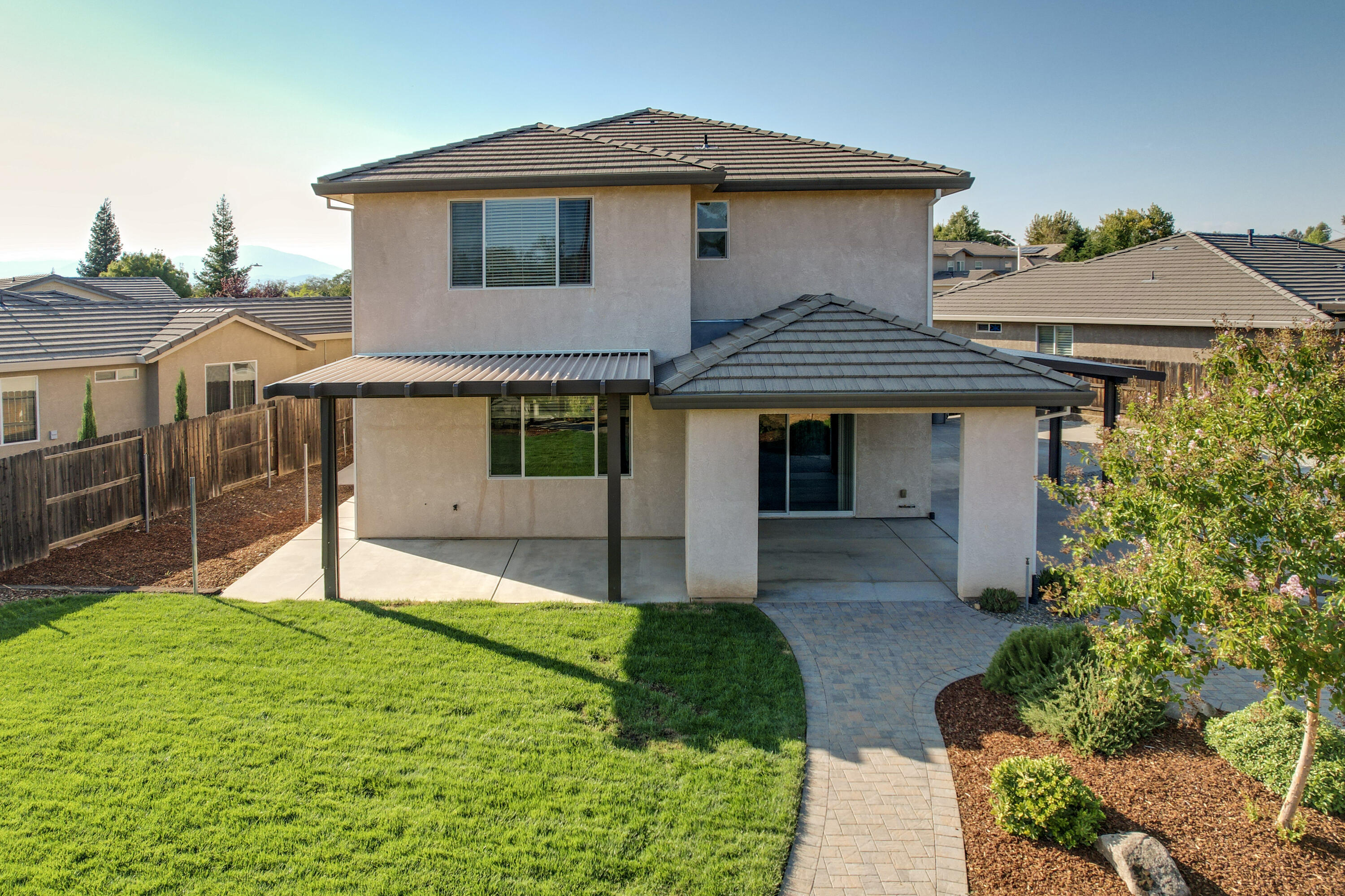 3863 Indian Wells Lane Redding, CA 96002 - Photo 36 of 63 a front view of a house with a yard