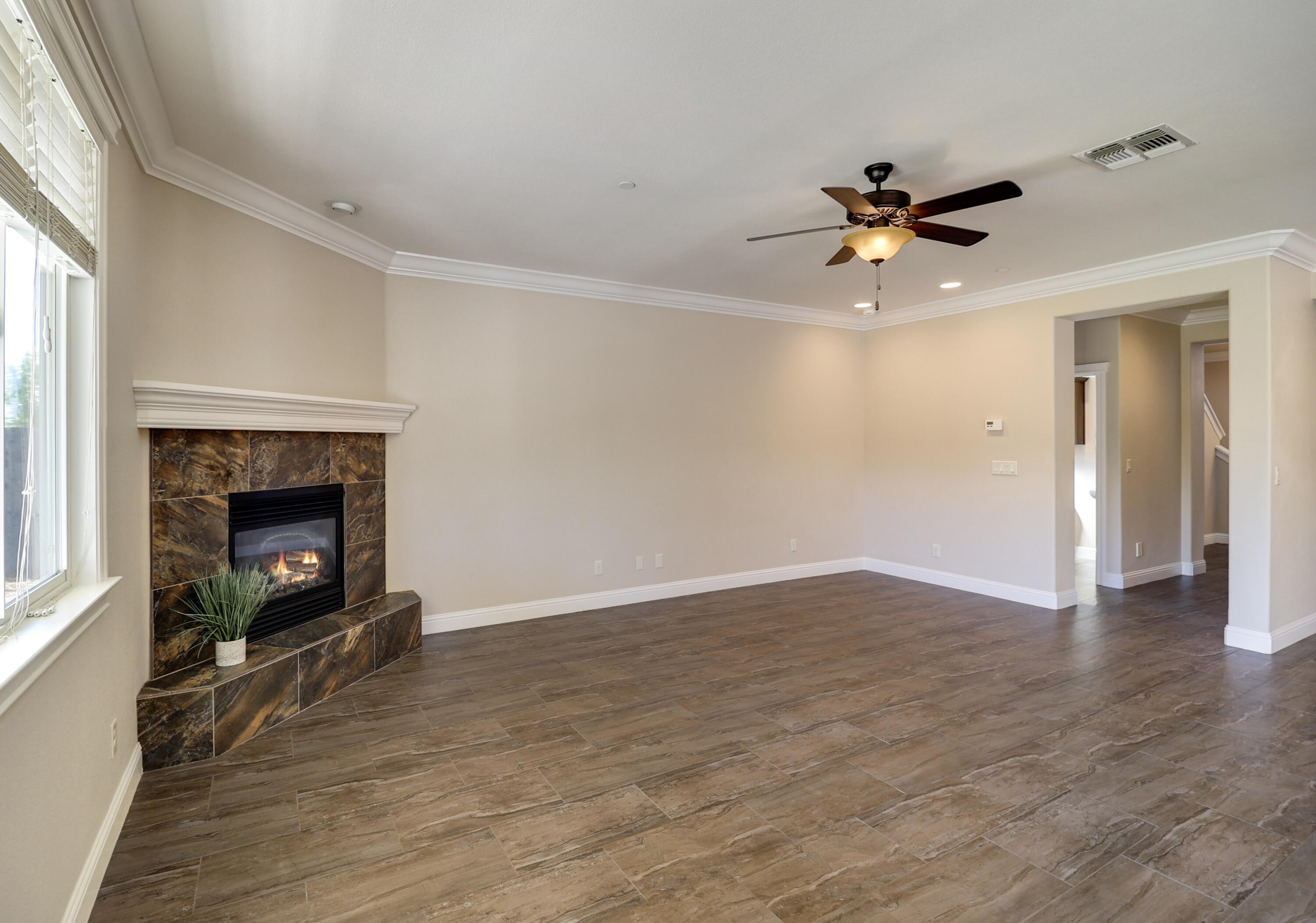 3863 Indian Wells Lane Redding, CA 96002 - Photo 8 of 63 a view of an empty room with a fireplace and a window