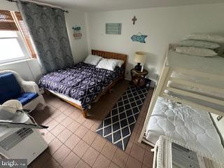 413 East Brigantine Avenue, Unit 29 Brigantine, NJ 08203 - Photo 5 of 10 a bed sitting in a bedroom next to a window