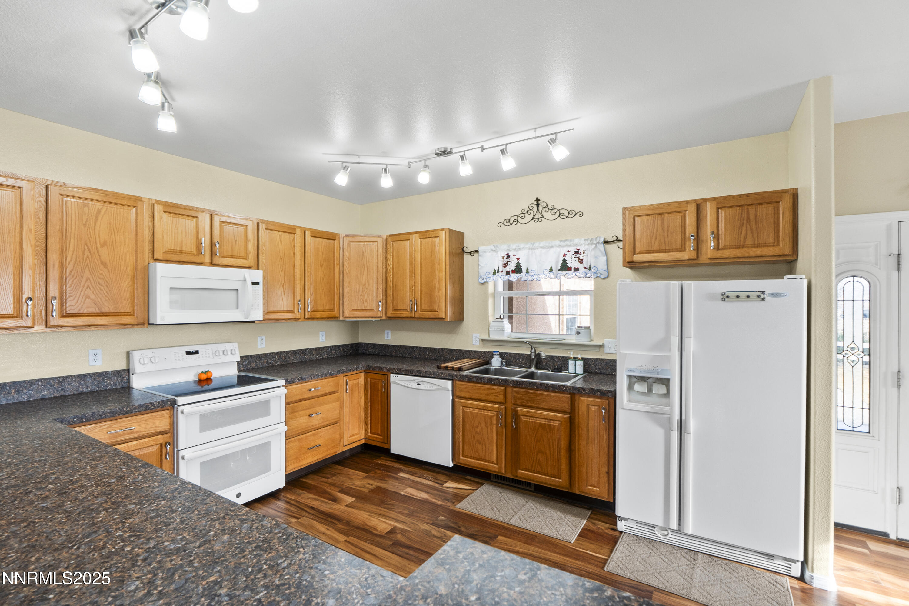 6990 Airport Road Winnemucca, NV 89445 - Photo 11 of 47 a kitchen with stainless steel appliances granite countertop a sink stove and refrigerator