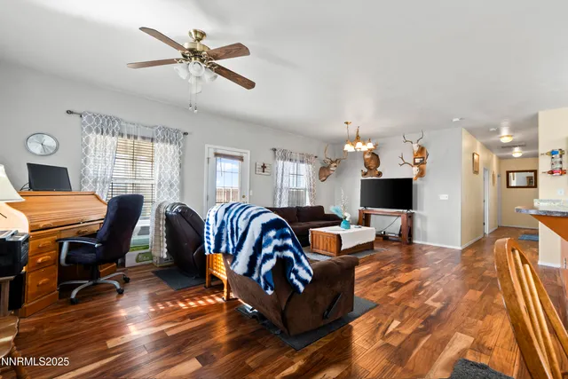 a living room with furniture a ceiling fan and a rug