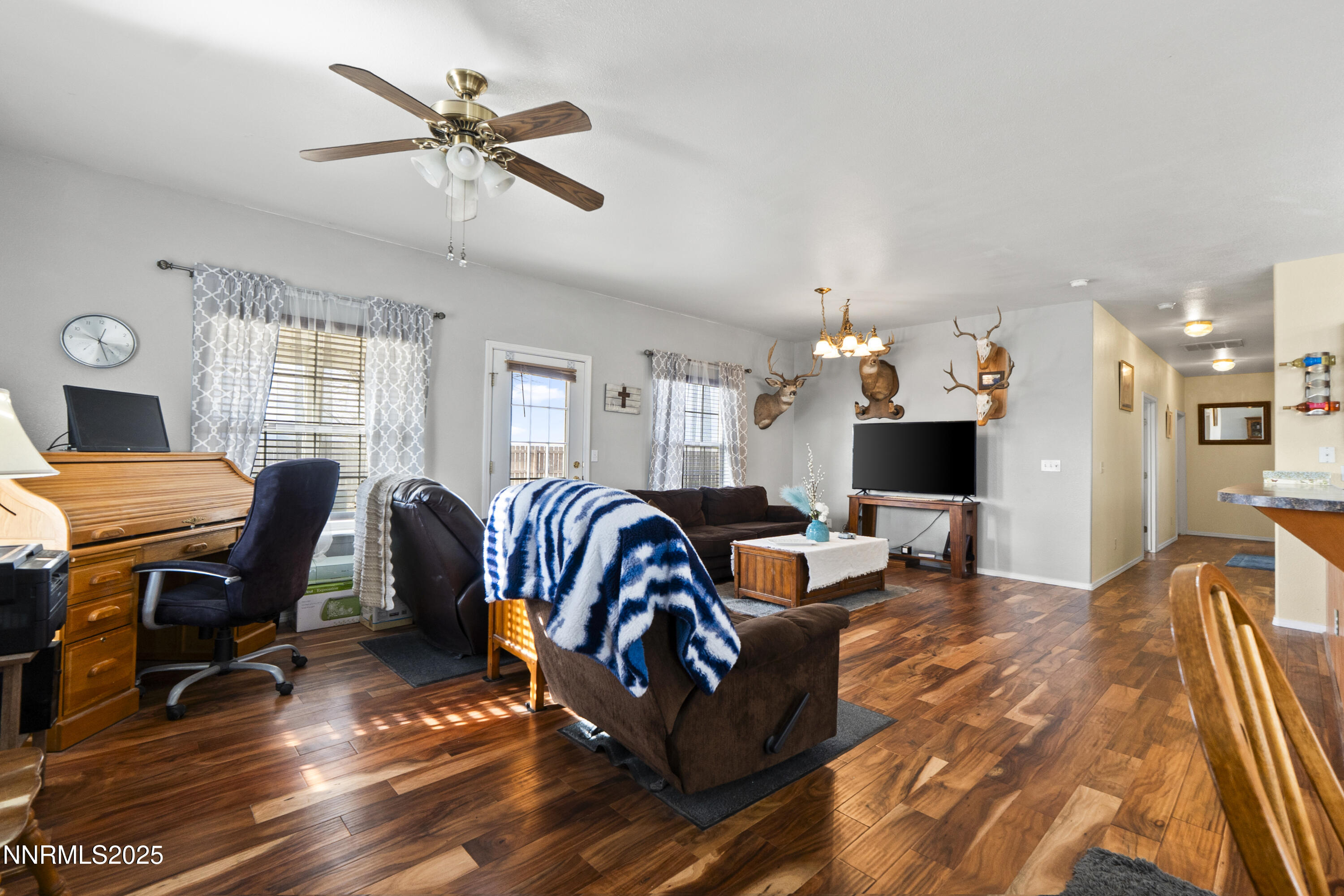 6990 Airport Road Winnemucca, NV 89445 - Photo 13 of 47 a living room with furniture a ceiling fan and a rug