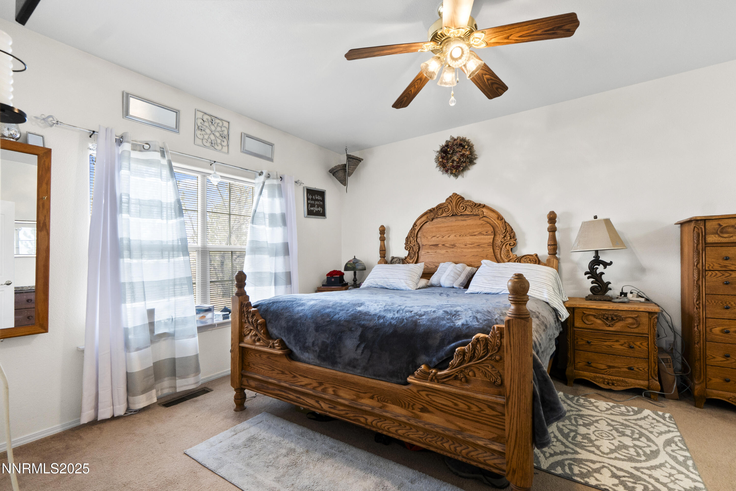 6990 Airport Road Winnemucca, NV 89445 - Photo 17 of 47 a bedroom with a bed next to a window and a chandelier