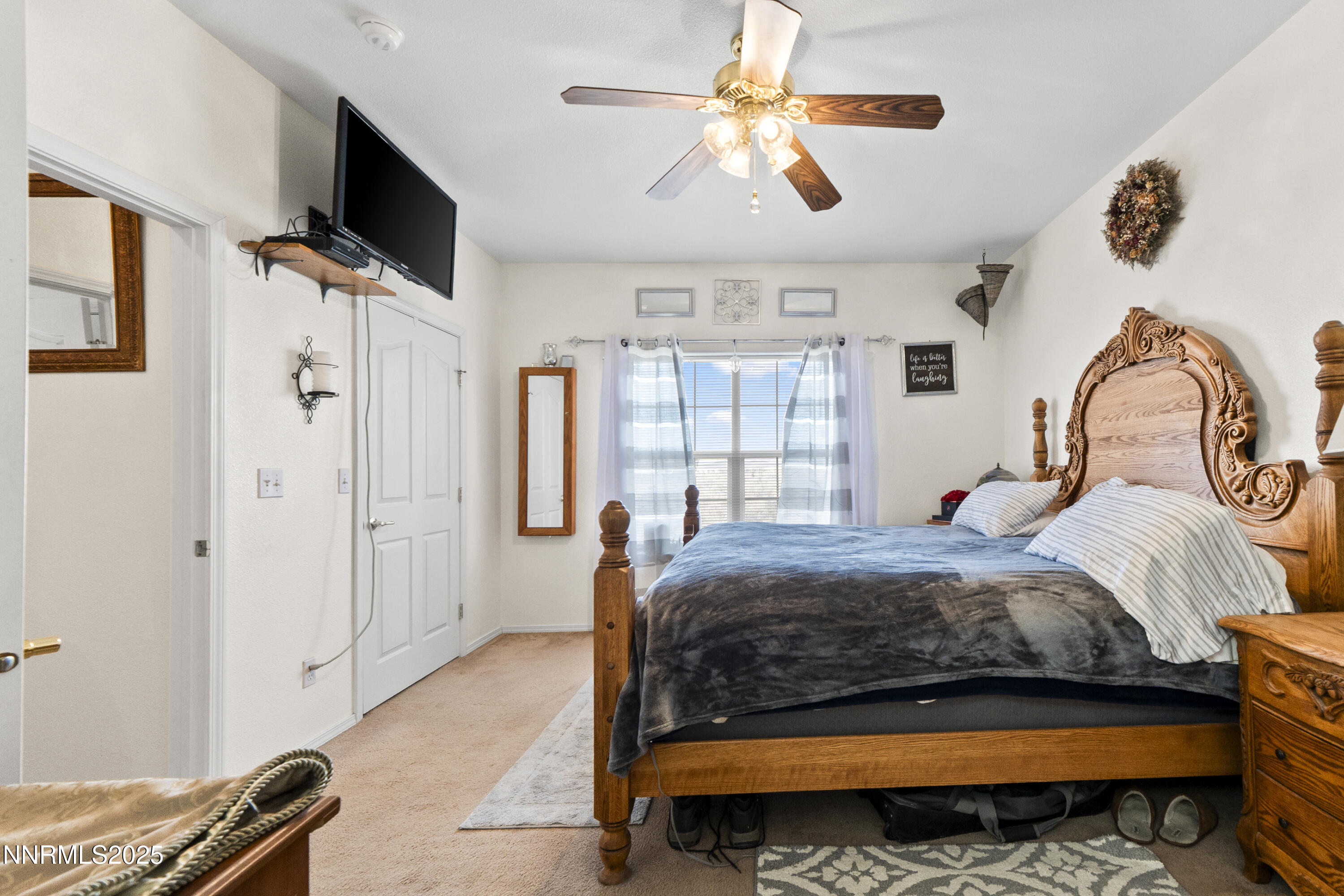 6990 Airport Road Winnemucca, NV 89445 - Photo 19 of 47 a bedroom with a bed flat screen tv and a window