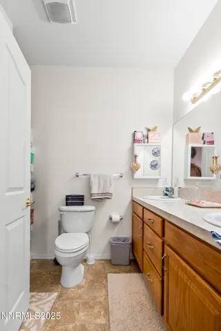 a spacious bathroom with a sink toilet and a mirror