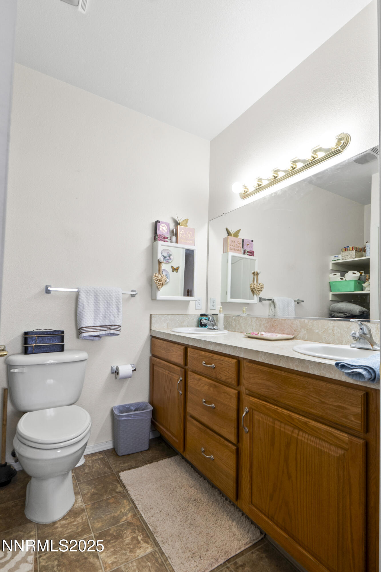 6990 Airport Road Winnemucca, NV 89445 - Photo 21 of 47 a spacious bathroom with a toilet a sink and a mirror