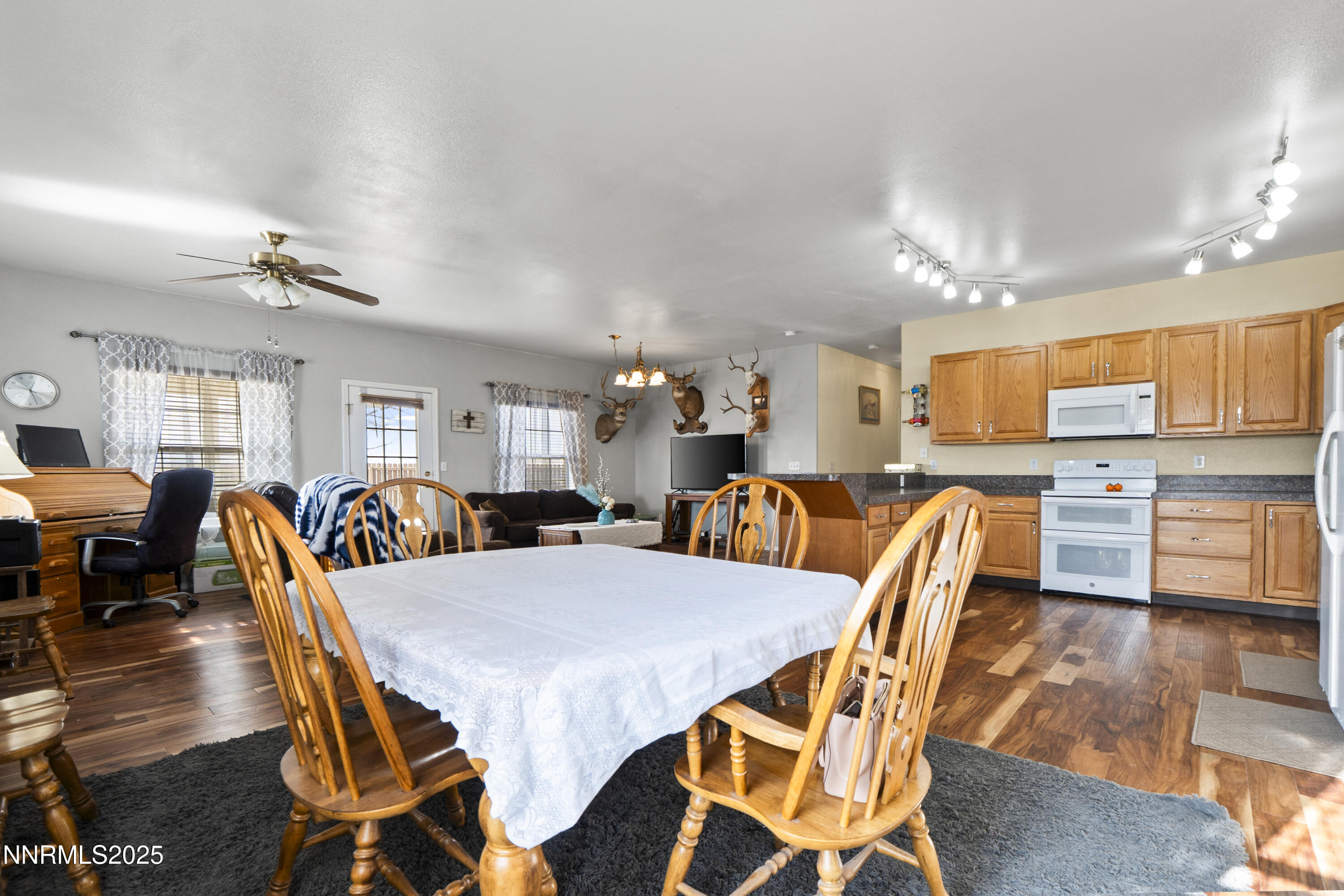 6990 Airport Road Winnemucca, NV 89445 - Photo 6 of 47 a view of a dining area with furniture and wooden floor