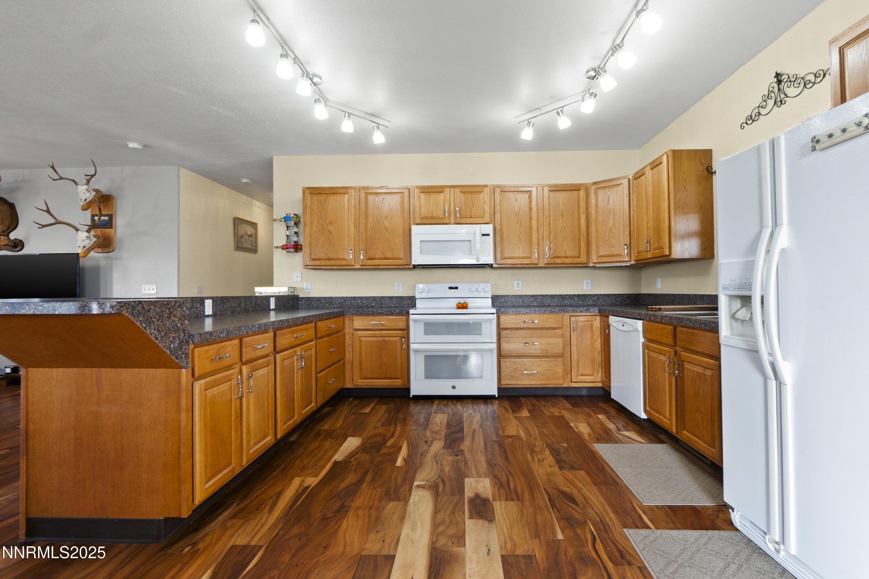 6990 Airport Road Winnemucca, NV 89445 - Photo 8 of 47 a kitchen with stainless steel appliances granite countertop a sink and cabinets