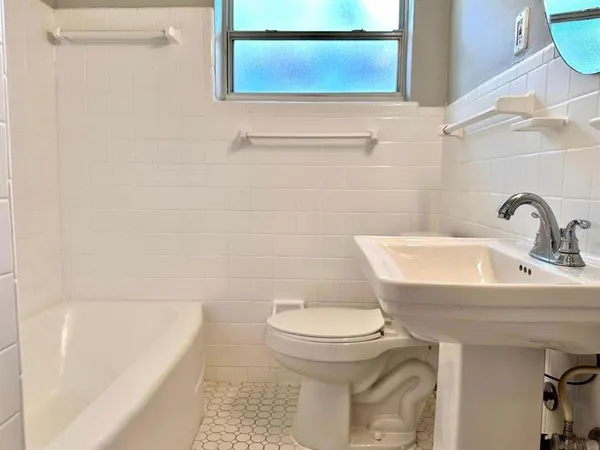 a bathroom with a sink a toilet and bathtub