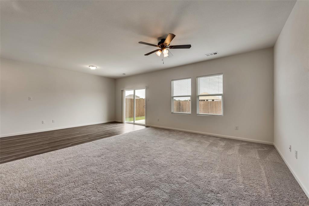 1608 Escondido Drive Haslet, TX 76052 - Photo 6 of 20 an empty room with windows and ceiling fan view