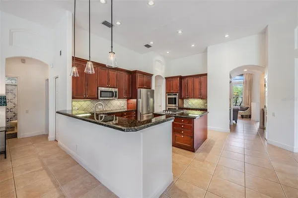 a living room with furniture a chandelier and a window