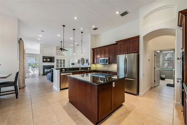 a view of a backyard with wooden floor and iron fence