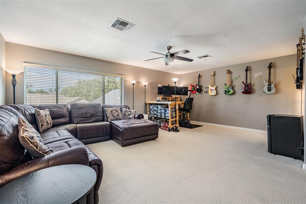 3727 Janus Way Palm Harbor, FL 34685 - Photo 37 of 98 a living room with furniture and a large window
