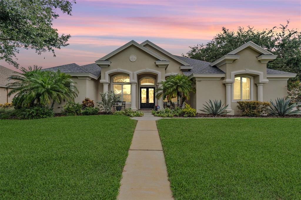 3727 Janus Way Palm Harbor, FL 34685 - Photo 55 of 98 a front view of a house with a garden and plants