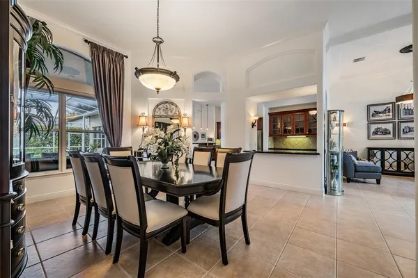 a kitchen with stainless steel appliances granite countertop a stove a refrigerator and a view of living room
