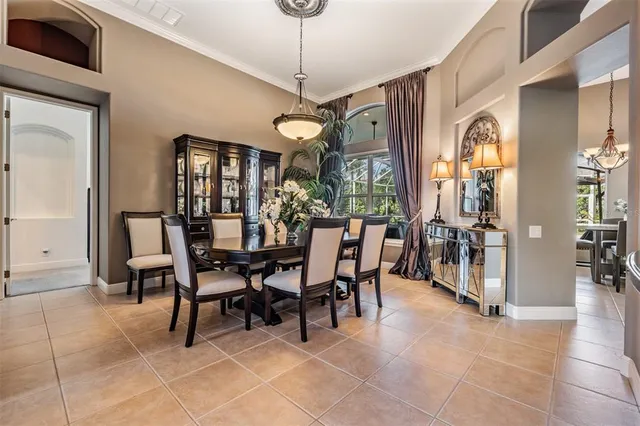 a kitchen with stainless steel appliances kitchen island granite countertop a dining table chairs refrigerator and microwave