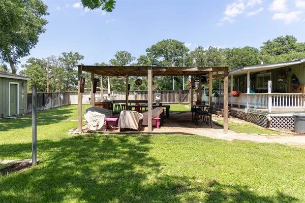 a view of a house with backyard and porch