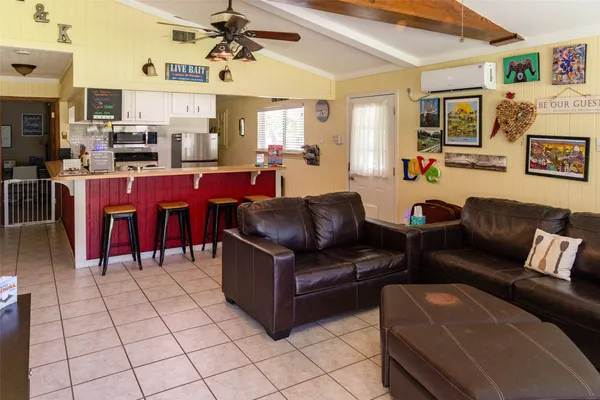 a living room with furniture and a kitchen view