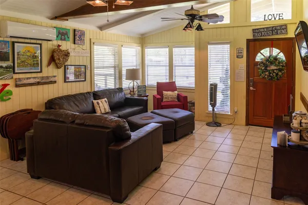 a living room with furniture and a floor to ceiling window