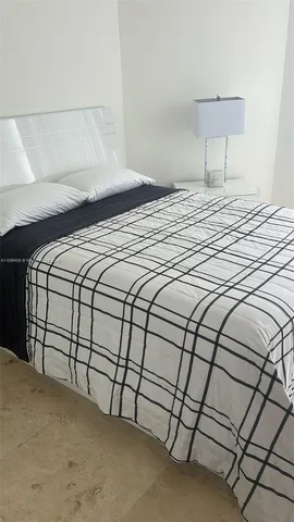 a bedroom with a bed and a night stand