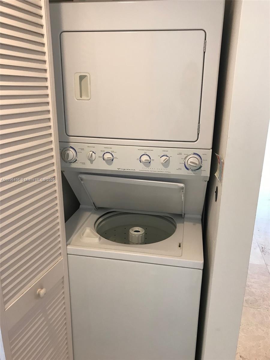 6365 Collins Avenue, Unit 1508 Miami Beach, FL 33141 - Photo 13 of 18 a close up view of a washer and dryer