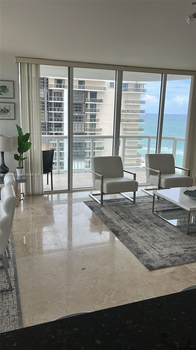 6365 Collins Avenue, Unit 1508 Miami Beach, FL 33141 - Photo 6 of 18 a view of living room with furniture and large windows
