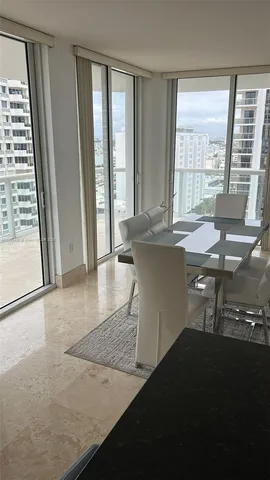 a view of a room with a table and chairs