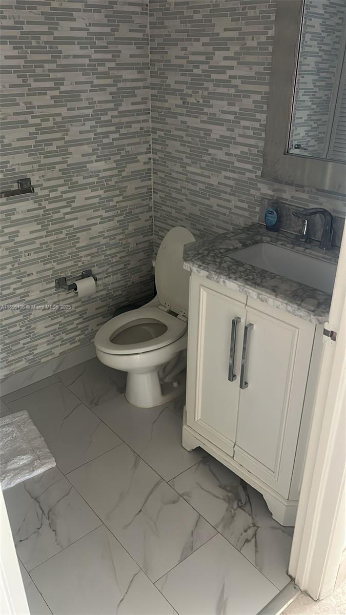 6365 Collins Avenue, Unit 1508 Miami Beach, FL 33141 - Photo 10 of 18 a bathroom with a toilet and a sink