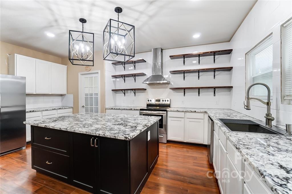 207 Old Carriage Road Clover, SC 29710 - Photo 16 of 48 a kitchen with stainless steel appliances granite countertop a sink stove and cabinets