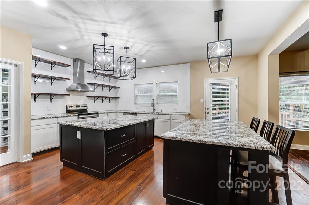 207 Old Carriage Road Clover, SC 29710 - Photo 17 of 48 a kitchen with stainless steel appliances granite countertop a stove and a wooden floors