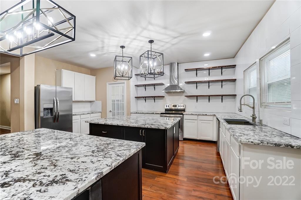 207 Old Carriage Road Clover, SC 29710 - Photo 18 of 48 a kitchen with stainless steel appliances granite countertop a sink stove and refrigerator