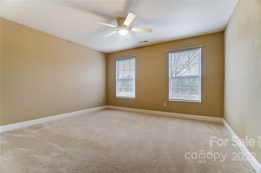 207 Old Carriage Road Clover, SC 29710 - Photo 30 of 48 an empty room with windows and chandelier fan