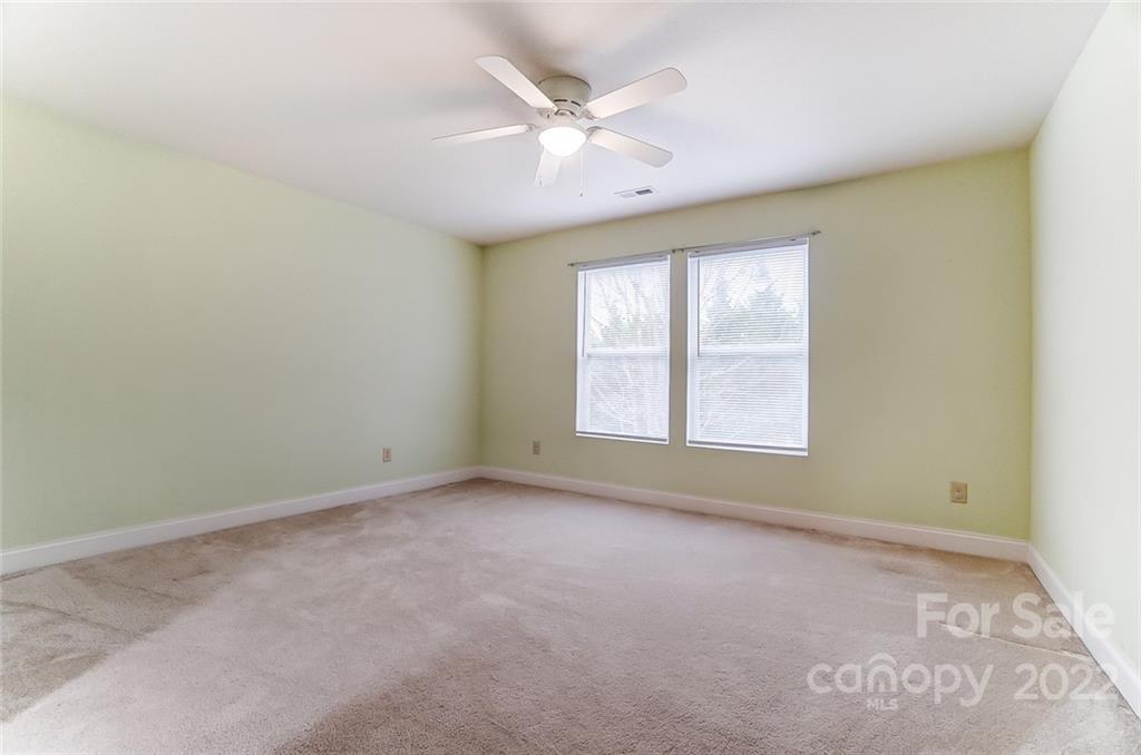 207 Old Carriage Road Clover, SC 29710 - Photo 39 of 48 an empty room with windows and ceiling fan