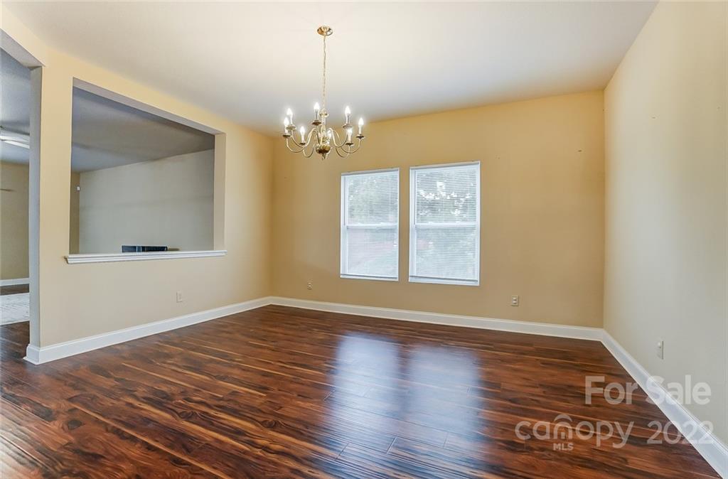 207 Old Carriage Road Clover, SC 29710 - Photo 8 of 48 a view of an empty room with wooden floor and a window