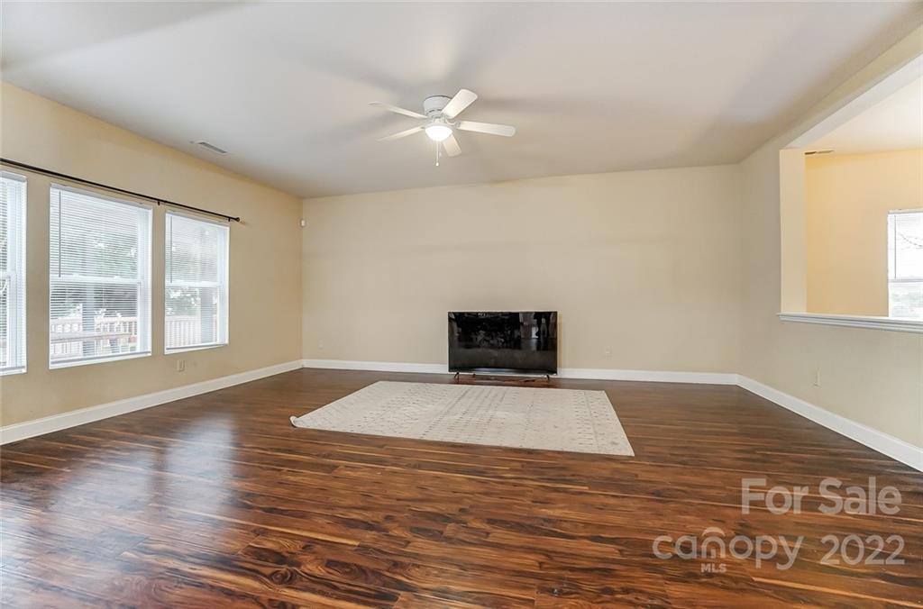 207 Old Carriage Road Clover, SC 29710 - Photo 9 of 48 a view of an empty room with wooden floor and a window