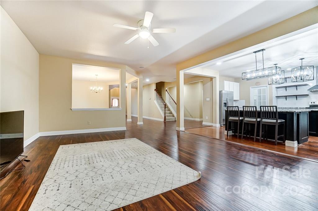 207 Old Carriage Road Clover, SC 29710 - Photo 10 of 48 a hallway with wooden floor and chandelier