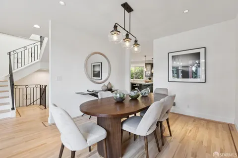 a large kitchen with stainless steel appliances granite countertop a sink and cabinets