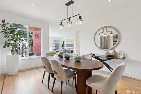 a kitchen with stainless steel appliances granite countertop a refrigerator a sink and a wooden floors