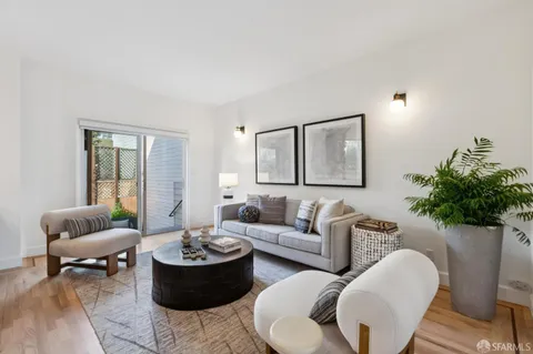 a view of a livingroom with wooden floor and stairs