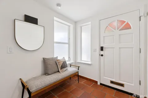 a living room with furniture potted plant and a window